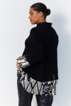 Plain knit sweater layered with print.