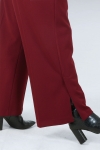 Flowing pants with high slits at the bottom